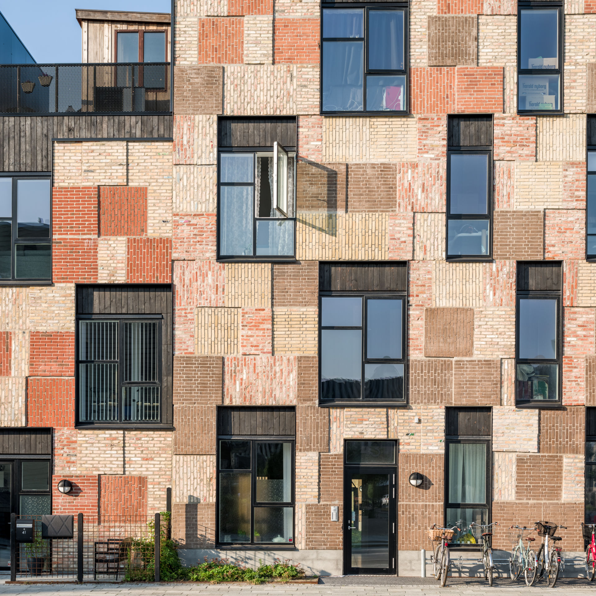 Najvýraznejším prvkom budov je patchworková tehlová fasáda.