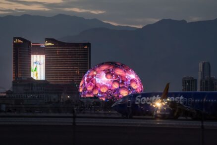 Airplane of Southwest Airlines landed in Harry Reid airport in Las Vegas with MSG Sphere light up on background on Strip